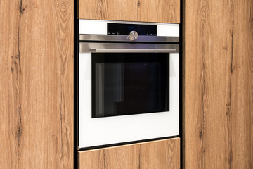 Built in modern oven in wooden cabinets