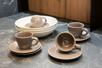 Brown ceramic coffee cups and saucers