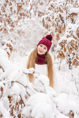 Smiling young woman outdoors in a winter forest