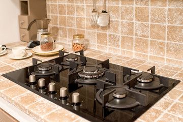 Fitted gas burner in a tiled kitchen counter