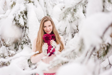 Smiling young woman outdoors in a winter forest