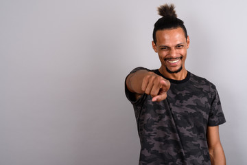 Fototapeta premium Young bearded handsome African man against gray background