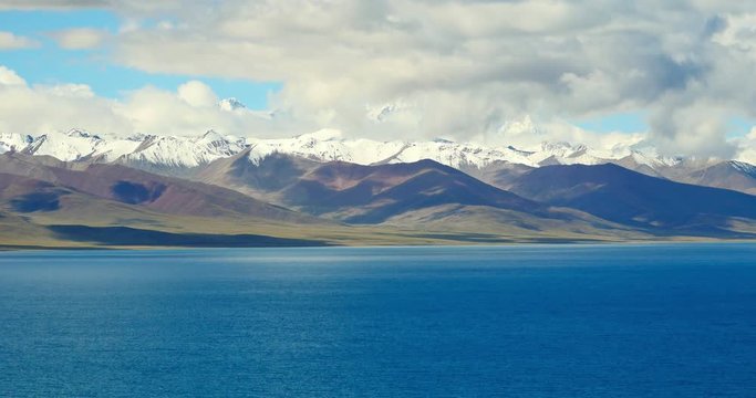 4k time lapse of huge clouds mass rolling over lake namtso & Tanggula snow mountain peak,tibet mansarovar,Tibet's second largest lake,is the third largest saltwater lake in China.