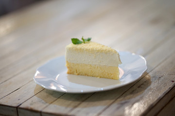 Homemade lemon cheese cake on light timber table