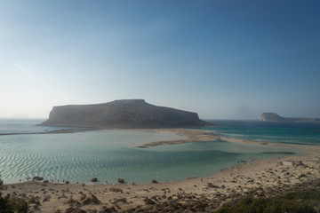 Gramvousa Peninsula, Crete - 09 25 2018: Balos Lagoon in windy weather. beach umbrellas