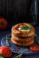 Three Homemade Mini Pizza with Tomatoes, Cheese and Bacon, Injuries and Spices on Light Blue Background