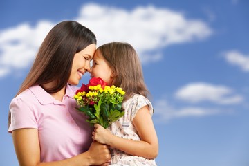 Young woman with little girl and beautiful