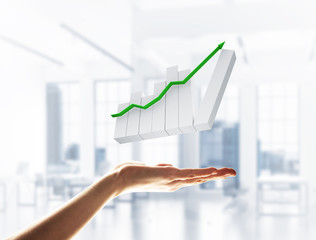 Concept of financial growth and progress by increasing arrow in palm