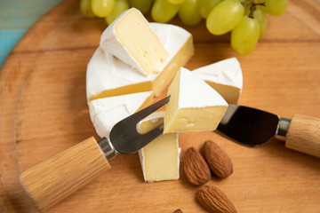 cheese camembert with raspberries and nuts on table