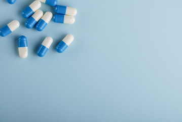 Blue and white capsules on blue