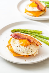Fototapeta na wymiar fried egg with bacon and cheese on pancake