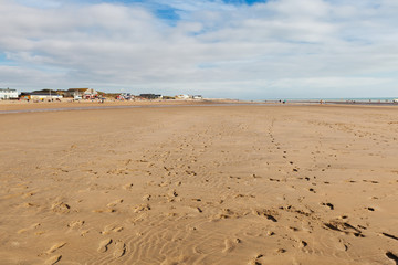Camber Sands, sandy beach at the village of Camber, East Sussex near Rye, England. Coastline in a low tide, selective focus