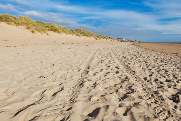 Camber Sands, sandy beach at the village of Camber, East Sussex near Rye, England, the only sand dune system in East Sussex. View of the dunes, grass, sea, selective focus