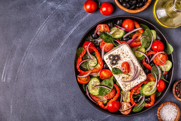 Greek salad of fresh cucumber, tomato, sweet pepper, spinach, red onion, feta cheese and olives