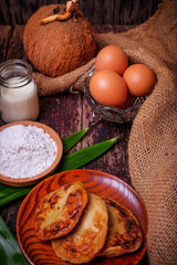 Akok Kedut, egg, coconut, flour , coconut milk and  Pandan leaf on wooden background. Akok Kedut is a traditional dish in Malaysia especially East Coast.