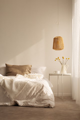 Natural material in bedroom, real photo with copy space on the empty wall