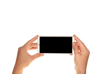 Mock-up of modern smartphone in the hands of a girl. Phone in horizontal position with a blank screen and isolated on white
