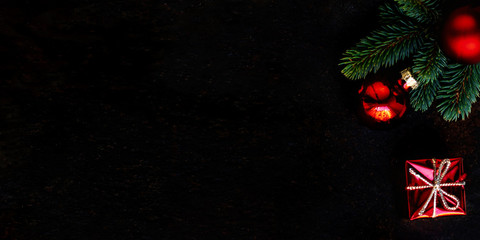 Christmas background with fir tree and decoration on dark blackboard. Flat lay. Christmas Greeting Card. Copyspace.