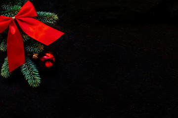 Christmas background with fir tree and decoration on dark blackboard. Flat lay. Christmas Greeting Card. Copyspace.