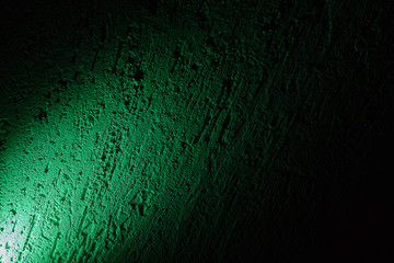 A reflection of green on a black background.