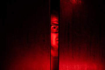 Agoraphobia concept / eye peeking behind the door - 230761212