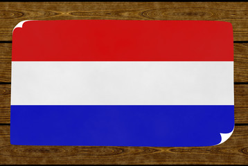 Illustration of a Dutch flag painted on the papier pasted on the woody wall