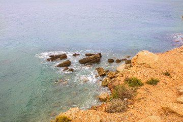 stormy cliffs on the Atlantic coast in Andalusia at high tide