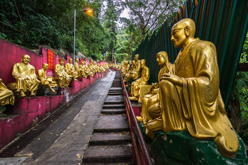 Gold painted Buddha statues on the steps up to the Ten Thousand Buddhas Monastery, each one with different poses, Hong Kong, Sha Tin, New Territories
