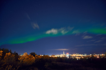 Fototapeta na wymiar northern lights above Reykjavik in Iceland at night