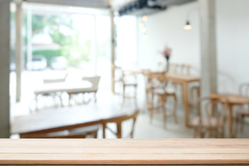 Montage wood table and cafe blur on background.