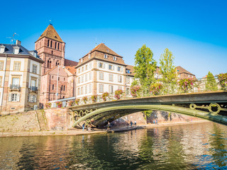 Fototapeta na wymiar Strasbourg, France - Aug 18, 2018: view of historic district in old town, nestles on an island formed by two arms of the River Ill. It is home to an impressive historic and architectural heritage