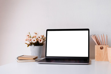 Mockup laptop computer on workspace with cup, pencil and computer.