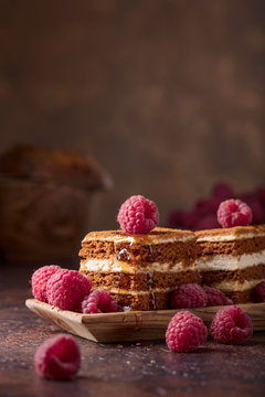 Layered honey cake with cream and raspberries.