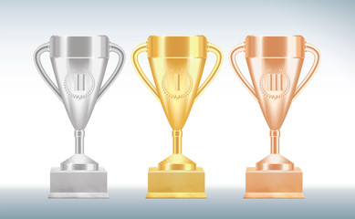 Set of golden, bronze and silver Trophy cups or goblets isolated on white background. Realistic Vector illustration