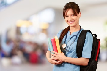 Attractive young female medical student with backpack