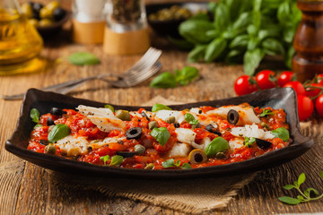 Cod in Italian in tomatoes with olives and capers.