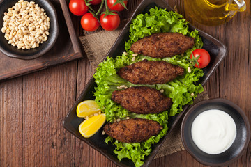 Traditional arabic kibbeh with lamb and pine nuts.