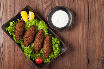 Traditional arabic kibbeh with lamb and pine nuts.