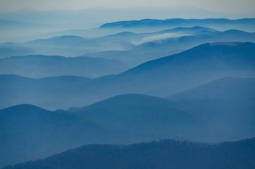 Beautiful morning alpine landscape with tonal perspective in blue tonality