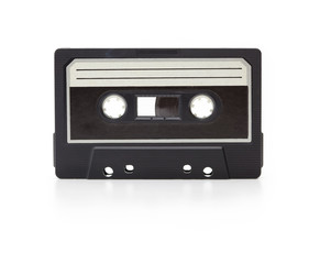 Early 70's cassette tape isolated on white with slight reflection. White blank label. (cassette is...