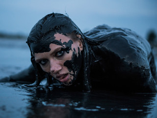 Portrait of Caucasian Girl Smeared in a Healthy Black Mud