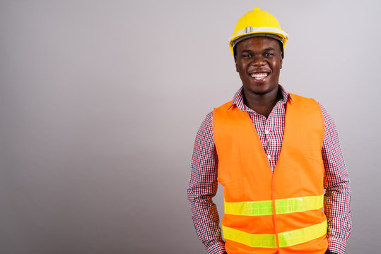 Young African man construction worker against white background