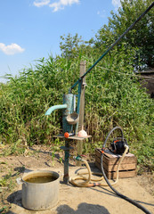 Irrigation system in the home garden. Well with manual and automatic pump