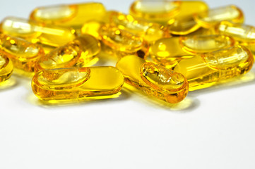 On a bright background. A large close-up on several capsules with a medicine.