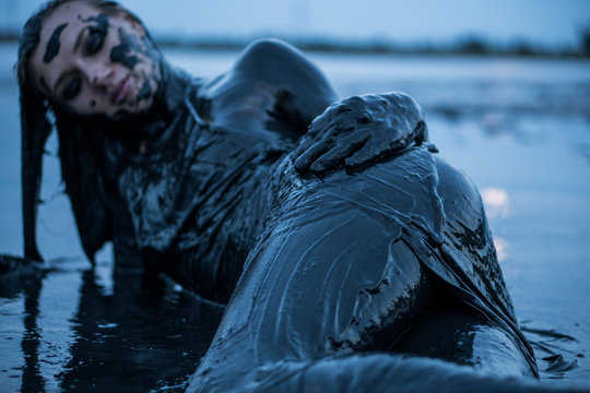Portrait of Caucasian Girl Smeared in a Healthy Black Mud