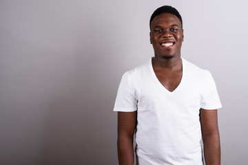 Portrait of young African man against white background