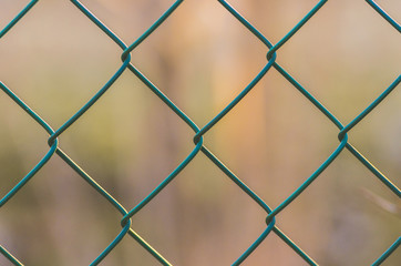 Diamond-shaped steel mesh fence close-up background