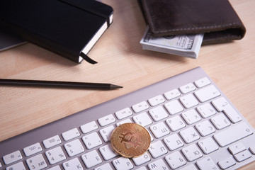 golden coin bitcoin on white keyboard