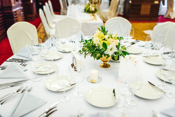 Wedding table set up. Indoor set up of a wedding/party table with  flower decoration