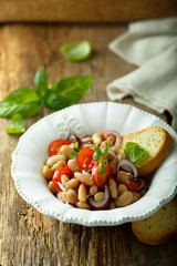 White bean salad with cherry tomatoes and red onion